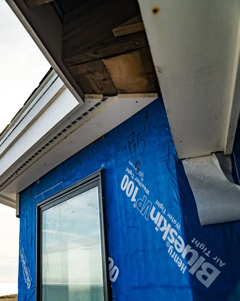 Schwanz Construction crew member working on an exterior wall